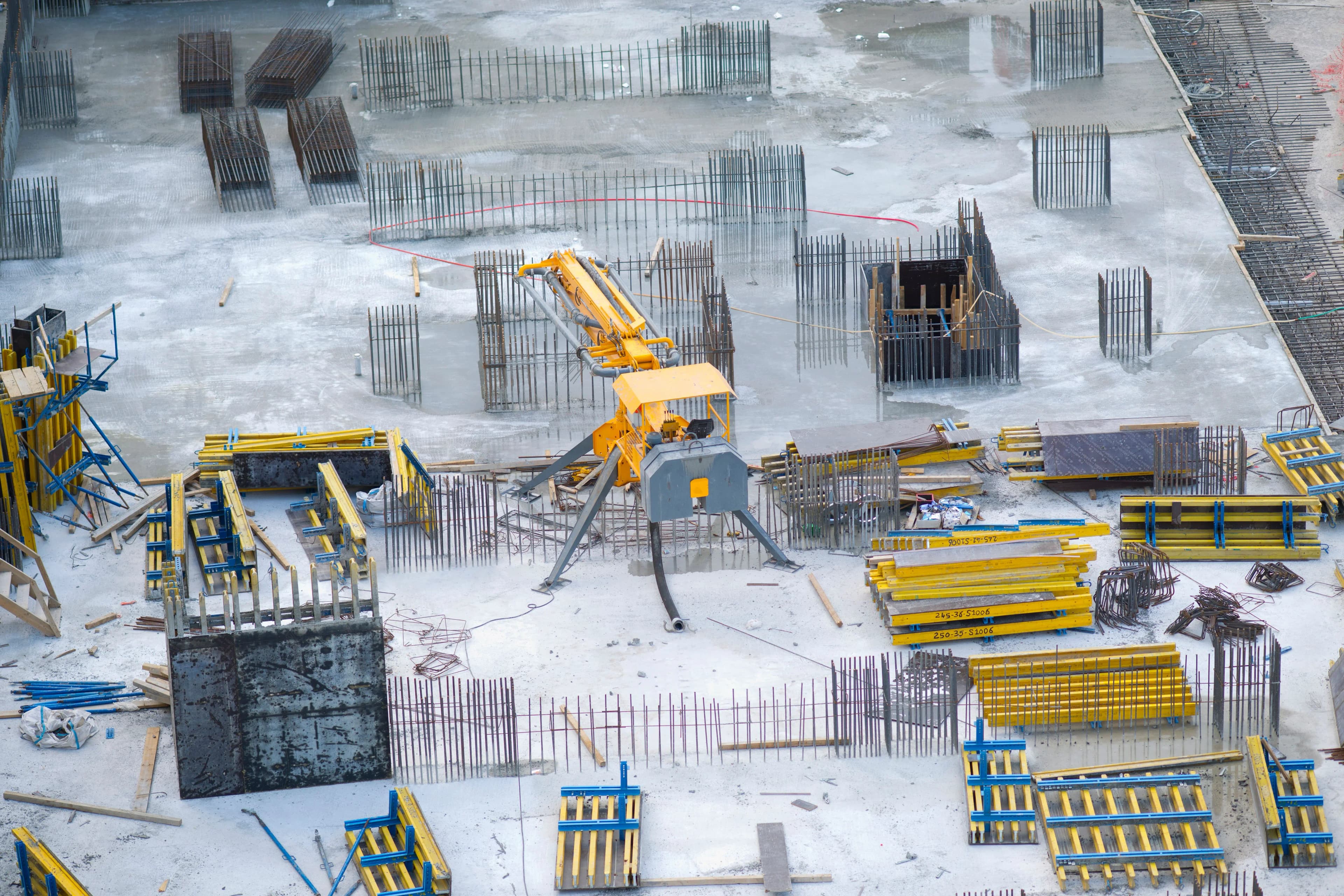 Aerial view of a construction site with formwork and a concrete pump