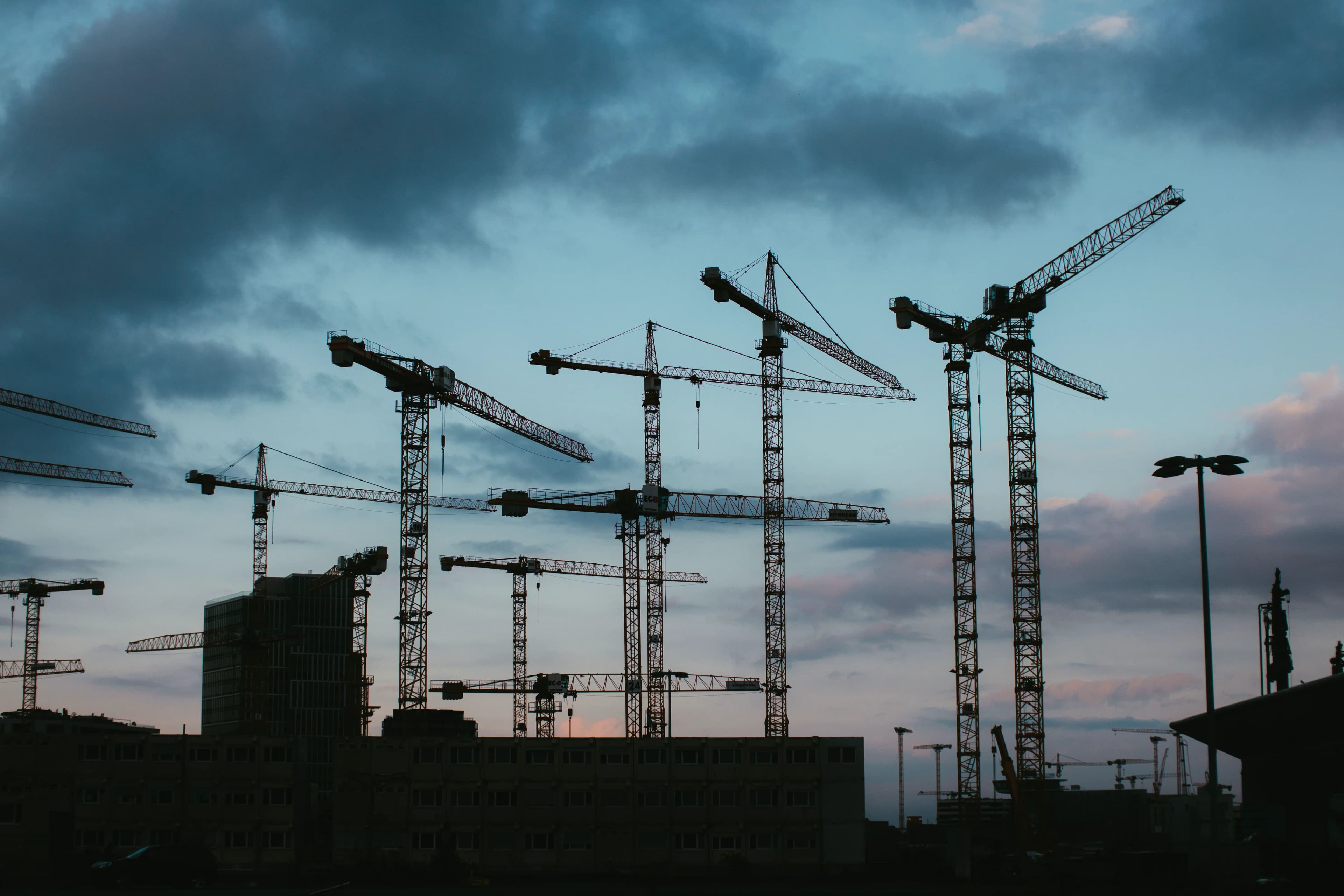 Tower cranes at a construction site at dusk